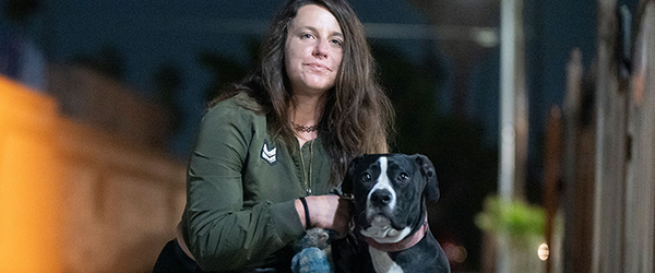 Rescue woman with dog at night, shelter and rescue mission volunteer, emotional support.