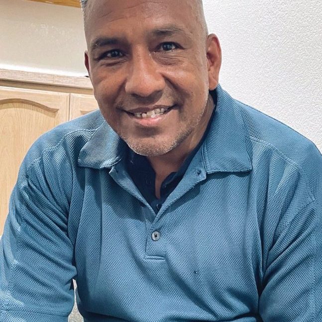 A compassionate man smiling, representing Rescue Mission Alliance community support.